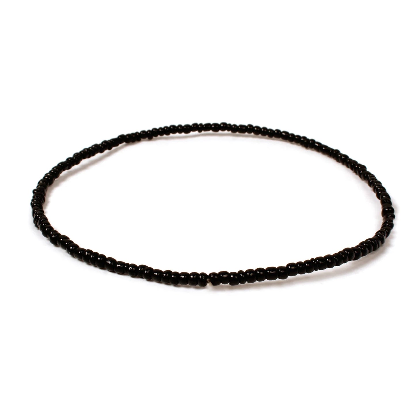 Handmade black beaded bracelet with small glossy glass beads arranged in a minimalist circular design on a white background