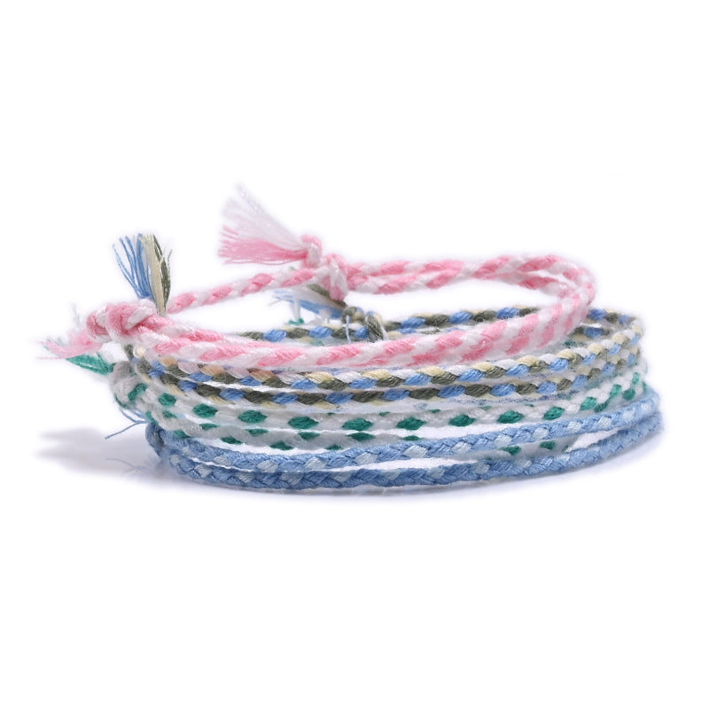 Multicolored braided bracelets on a white background