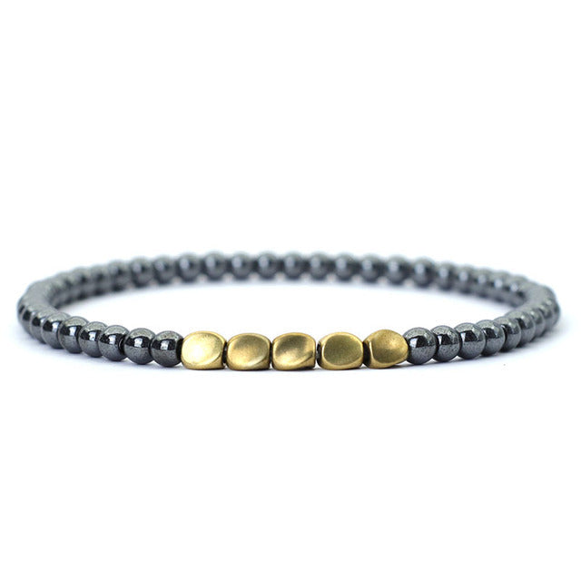 Minimalist black hematite beaded bracelet with matte gold center accents