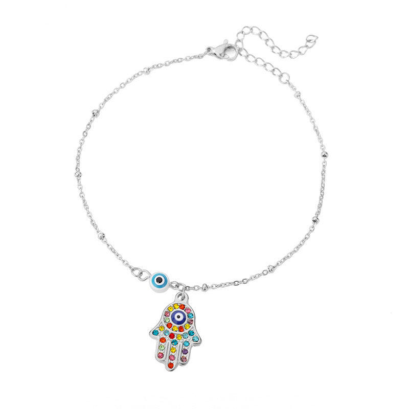 Silver chain bracelet with Hamsa hand charm, featuring colorful gemstones and an evil eye pendant