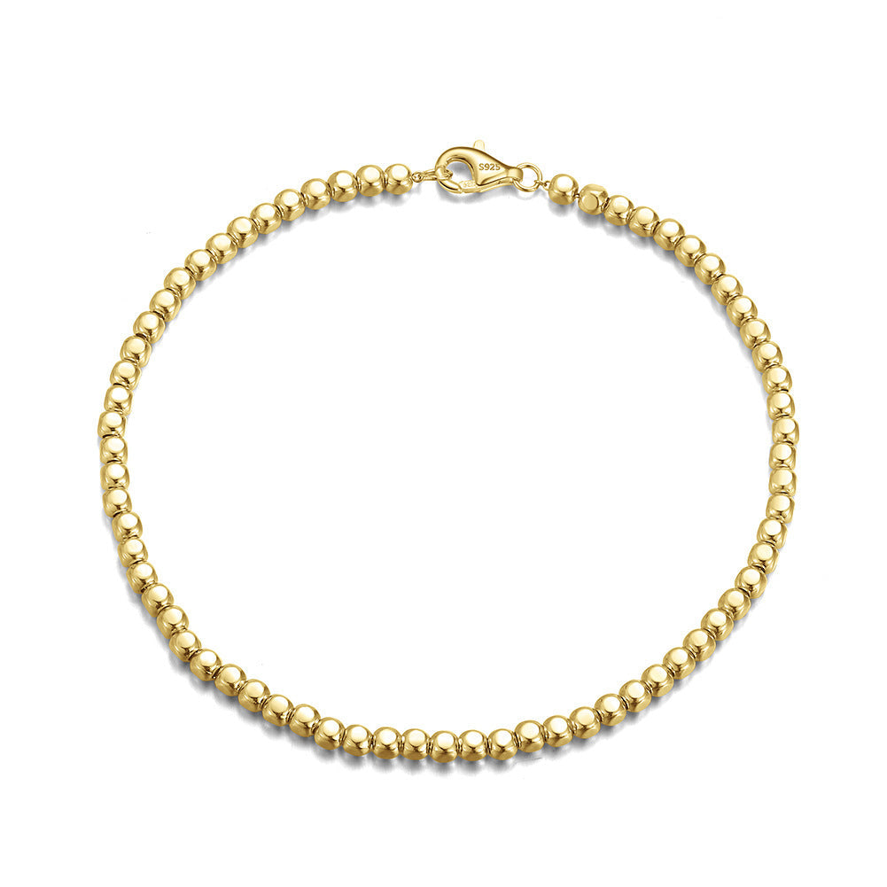Gold bracelet with a 'Real Sterling Silver 925' stamp on a white background