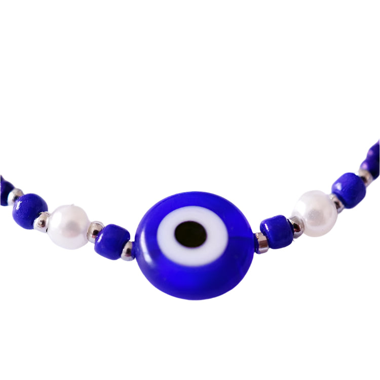Bracelet with blue and white beads on a white background