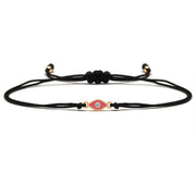Black cord bracelet with a decorative clasp on a white background