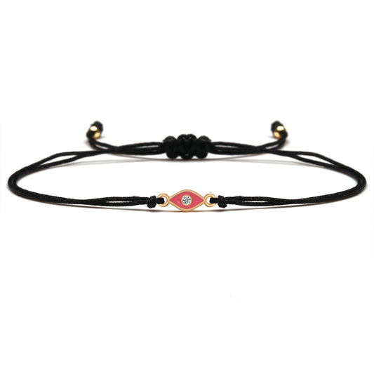 Black cord bracelet with a decorative clasp on a white background