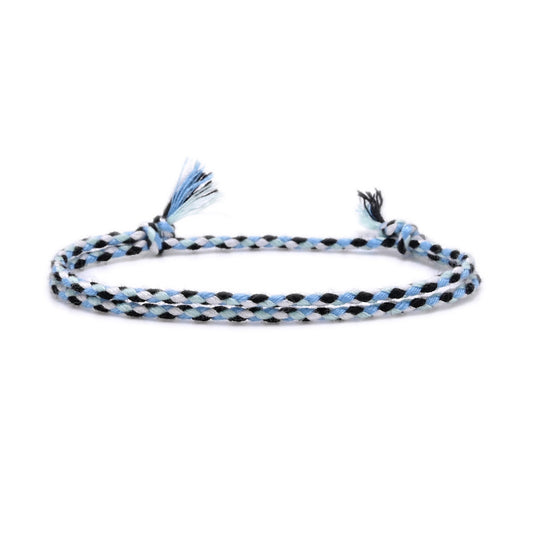 Braided bracelet with blue and black pattern on a white background