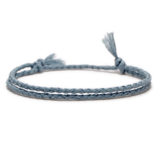 Sky Blue Braided Bracelet with adjustable tassel ends, handcrafted for a minimalist and timeless look.