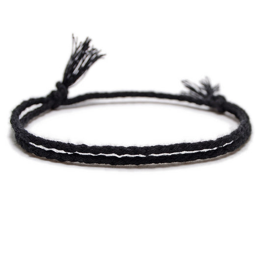 A sleek black braided bracelet with a handcrafted design and adjustable knotted closure, offering a modern and minimalistic look.