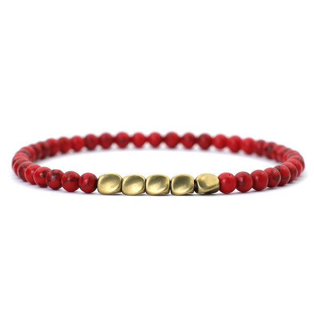 Red beaded bracelet with matte gold center accents