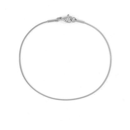 Minimalistic silver snake chain bracelet with lobster clasp, shown in a circular form.