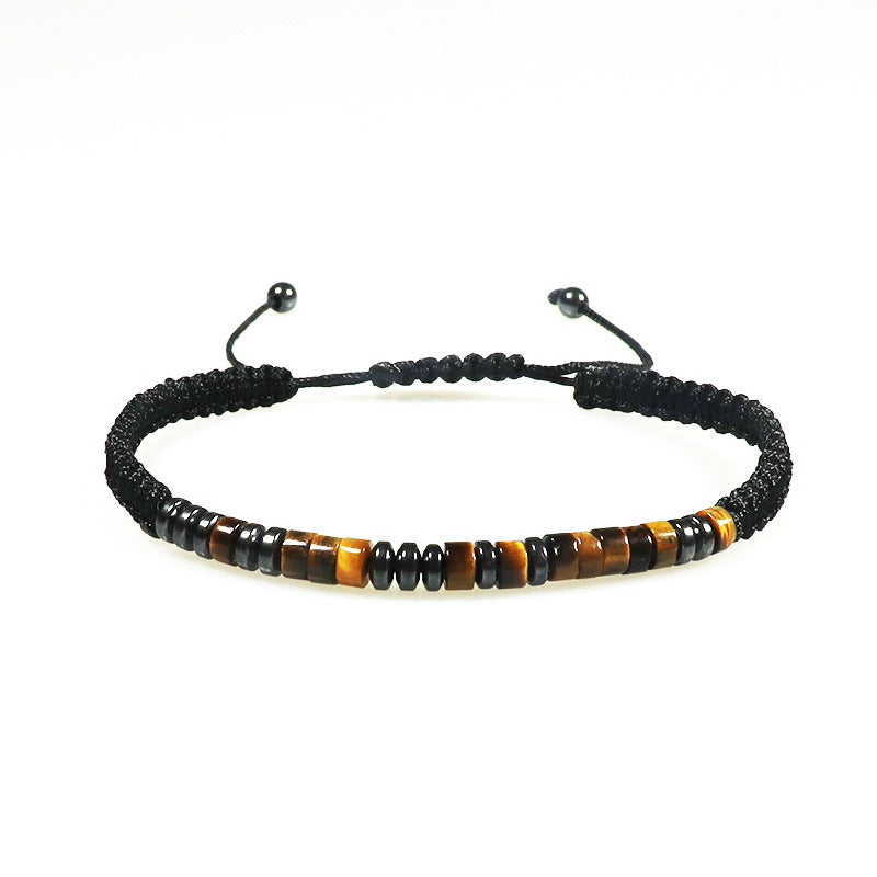 A close-up of a handmade black braided bracelet featuring alternating tiger eye and obsidian beads.