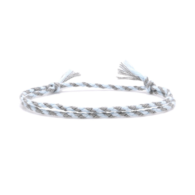 Braided cotton bracelet in ice blue and grey, double-braid style with tassel ends