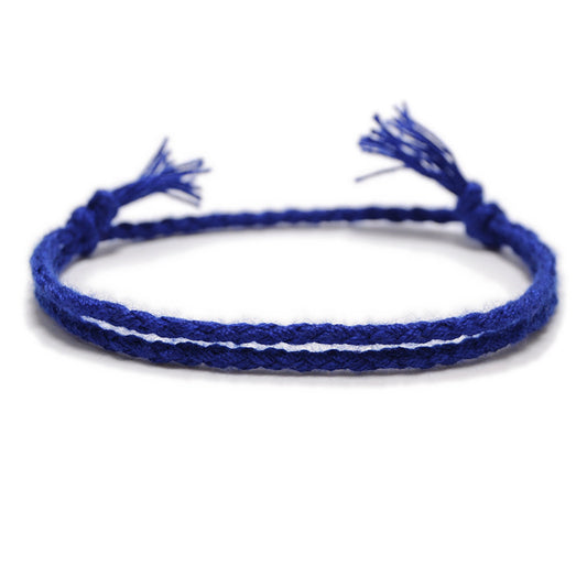 A deep blue woven bracelet with an adjustable knot closure, featuring a double-braided design and fine handcrafted details.