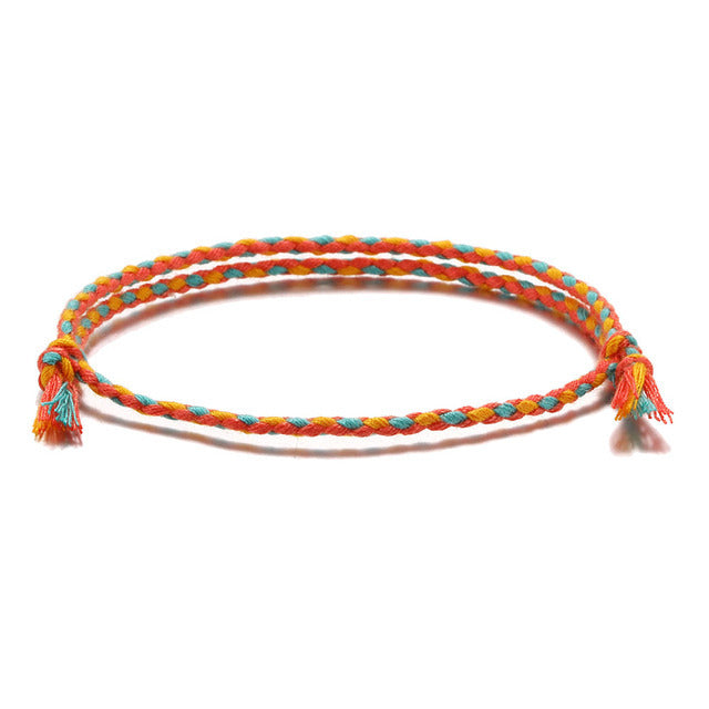 Resilience bracelet with Tibetan-inspired knots and handcrafted string design.