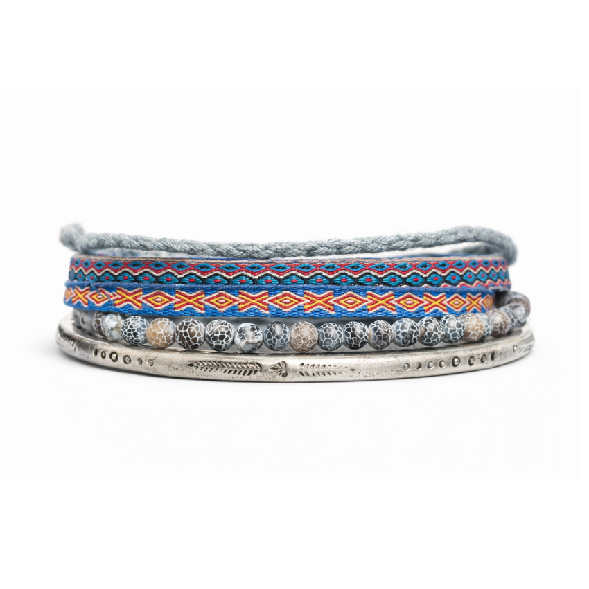 Set of three bracelets with patterned bands on a white background