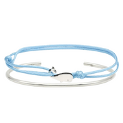 Silver bangle with light blue cord bracelet featuring a silver dolphin charm – minimalist nautical-inspired design.