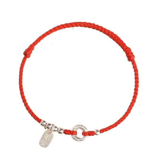 Handwoven red bracelet with authentic S925 silver charm and centerpiece on white background