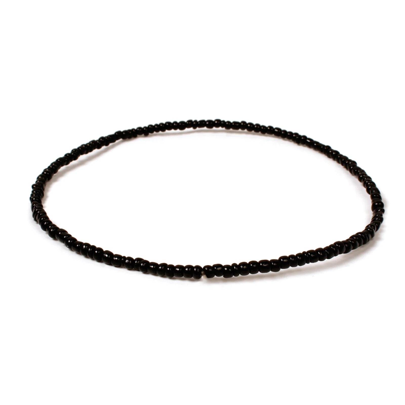Handmade black beaded bracelet with small glossy glass beads arranged in a minimalist circular design on a white background