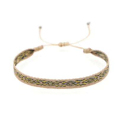 Handwoven bracelet in orange, blue, turquoise, and grey with a diamond pattern and adjustable pull-tie closure.