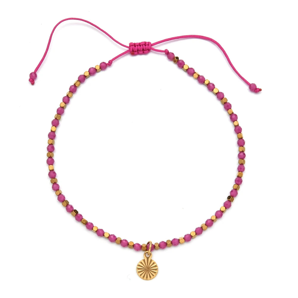 Pink and gold bracelet with golden charm