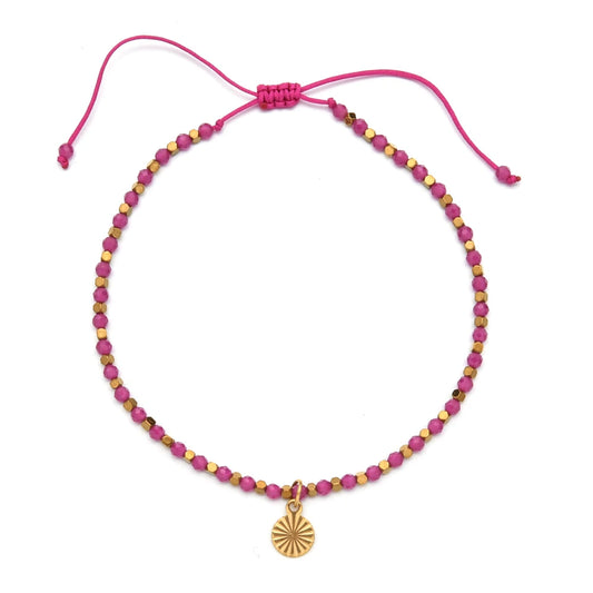 Pink and gold bracelet with golden charm