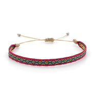 Colorful woven bracelet with red, green, and yellow patterns on a beige adjustable cord – part of the Azure Collection by Rue & Strand.