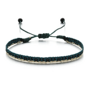 Teal and black woven bracelet with geometric pattern on beige background, adjustable cord design
