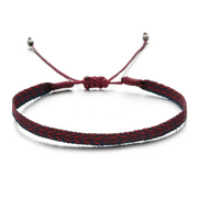Bracelet with red and black braided cord on a white background