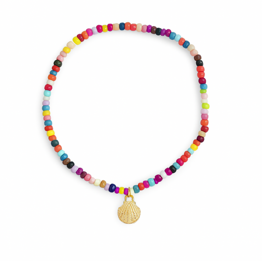 Colorful beaded bracelet with gold shell charm on white background