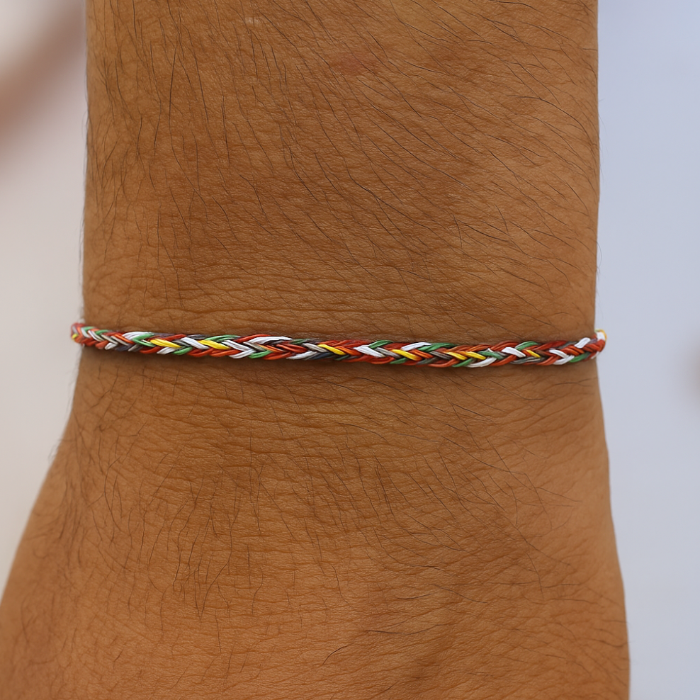 Colorful braided bracelet on a wrist with a neutral background