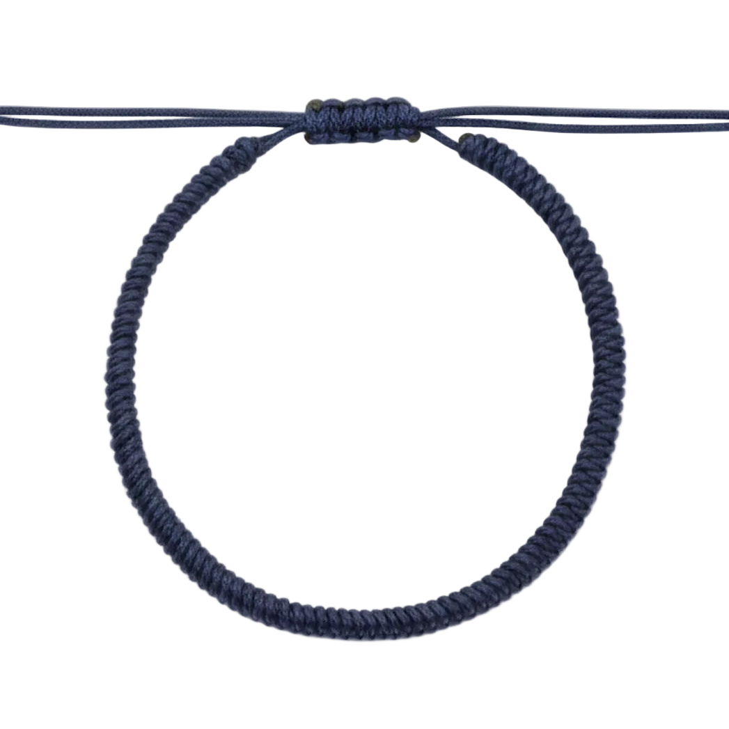 Navy blue hair tie on a white background