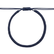 Navy blue hair tie on a white background