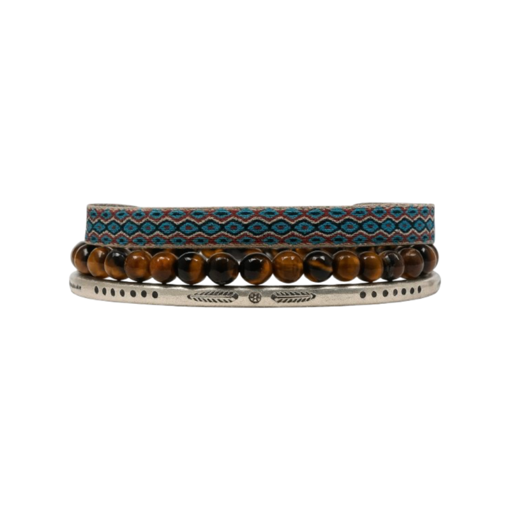 A bracelet stack featuring a red-turquoise woven band, brown gemstone beads, and a silver engraved cuff bracelet.
