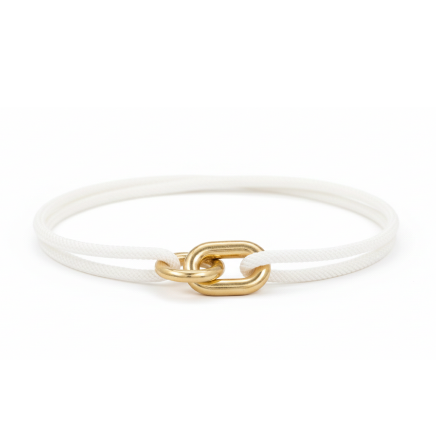 White bracelet with a gold clasp on a white background