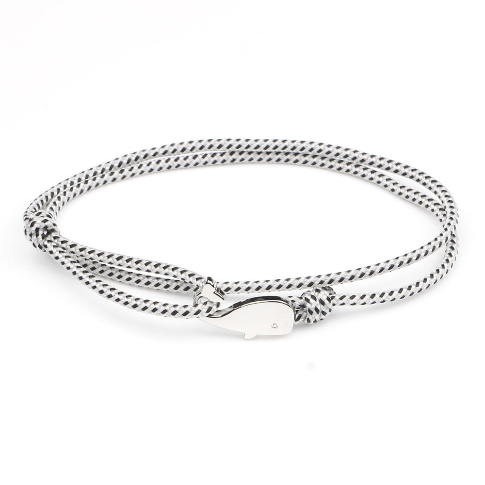 White and black bracelet with silver whale charm