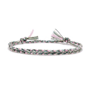 Braided bracelet with pink and green pattern on a white background