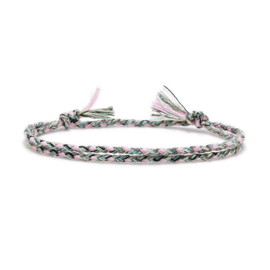 Braided bracelet with pink and green pattern on a white background