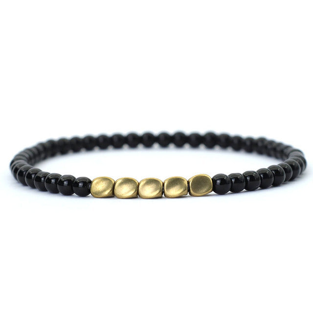 Black stone beaded bracelet with matte gold center accents