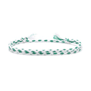 Handmade double braided friendship bracelet in emerald green and white cotton thread, styled on wrist