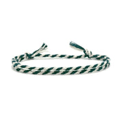 Green and white braided bracelet on a white background
