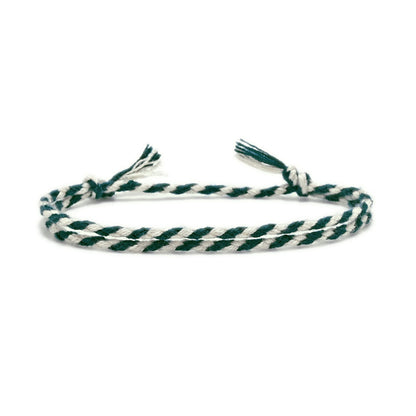 Green and white braided bracelet on a white background