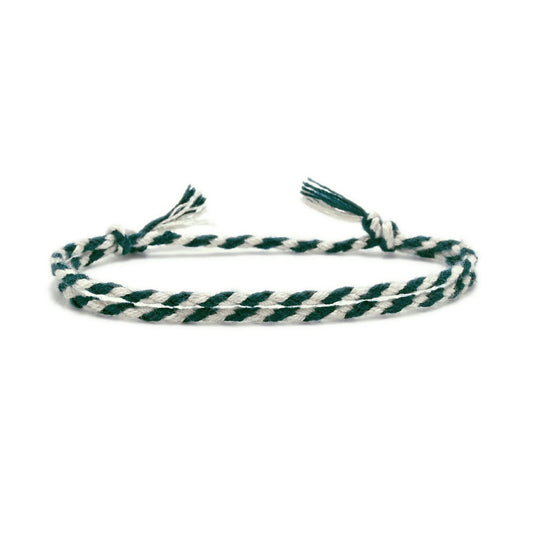 Green and white braided bracelet on a white background