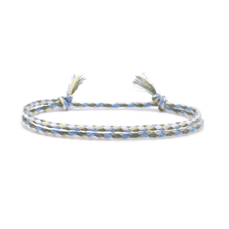 Braided friendship bracelet in sage, blue, and off-white cotton with tassel ends – Rue & Strand