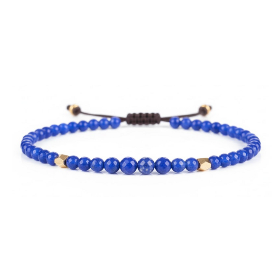 Blue beaded bracelet with gold accents on a white background