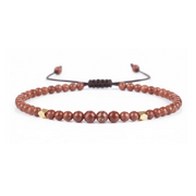 Beaded bracelet with brown and gold beads on a white background